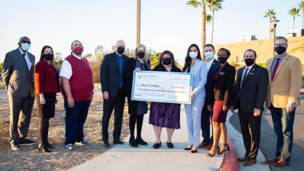 Assemblymember and stakeholders hold big check